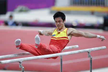 China's Dong Zhendong competes during the men's parallel bars final at the Doha Gymnastics World Cup at the Aspire Academy in Doha, capital of Qatar, Sept. 30, 2009. Dong won the gold medal of the event. (Xinhua/Chen Shaojin)