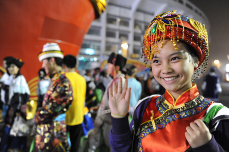 A child performer waves as the performers of the National Day celebrations gather at the Workers Stadium in the early morning in Beijing, on Oct. 1, 2009. China will celebrate on Oct. 1 the 60th anniversary of the founding of the People's Republic of China. 