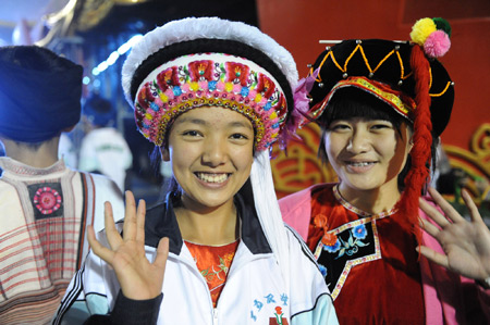 Children performers wave as they gather at the Workers Stadium in the early morning in Beijing, on Oct. 1, 2009. China will celebrate on Oct. 1 the 60th anniversary of the founding of the People's Republic of China.