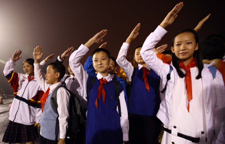 Young Pioneer performers of the National Day celebrations practise salute while gathering at the Workers Stadium in the early morning in Beijing, on Oct. 1, 2009. China will celebrate on Oct. 1 the 60th anniversary of the founding of the People's Republic of China. 