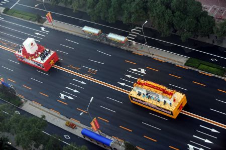 Floats move to a designated place to prepare for the celebrations for the 60th anniversary of the founding of the People's Republic of China, in Beijing, capital of China, Oct. 1, 2009.