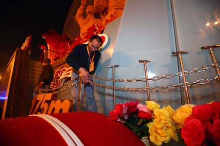 Staff members inspect a float that will take part in the celebrations for the 60th anniversary of the founding of the People's Republic of China, in Beijing, capital of China, Oct. 1, 2009.(