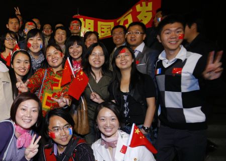 Chinese students pose for photos during a celebration for the 60th anniversary of the founding of the People's Republic of China, in Paris, France, Sept. 30, 2009.(