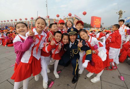 Pupils attending the celebrations for the 60th anniversary of the founding of the People's Republic of China, walk into the Tian'anmen Square in central Beijing, capital of China, Oct. 1, 2009.(