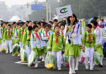 Pupils attending the celebrations for the 60th anniversary of the founding of the People's Republic of China, walk into the Tian'anmen Square in central Beijing, capital of China, Oct. 1, 2009.(