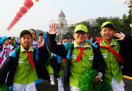Pupils attending the celebrations for the 60th anniversary of the founding of the People's Republic of China, walk into the Tian'anmen Square in central Beijing, capital of China, Oct. 1, 2009.