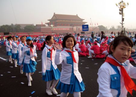 Pupils attending the celebrations for the 60th anniversary of the founding of the People's Republic of China, walk into the Tian'anmen Square in central Beijing, capital of China, Oct. 1, 2009. 