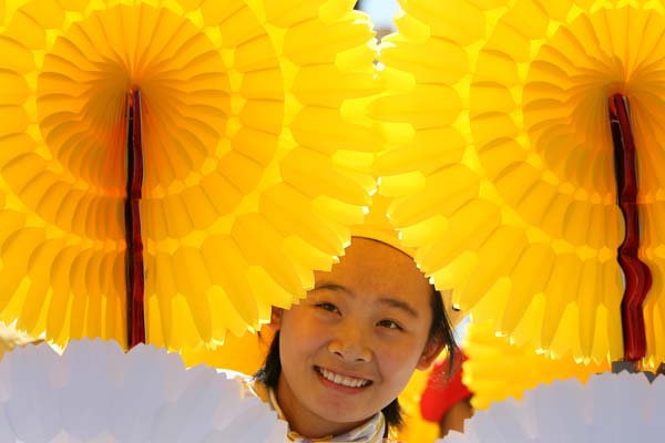 A student holds paper flowers while attending the celebrations for the 60th anniversary of the founding of the People's Republic of China, in central Beijing, capital of China, Oct. 1, 2009. 