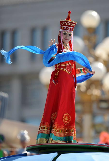 A girl waves hands on top of a float when taking part in a parade of the celebrations for the 60th anniversary of the founding of the People's Republic of China, on Chang'an Street in central Beijing, capital of China, Oct. 1, 2009. 