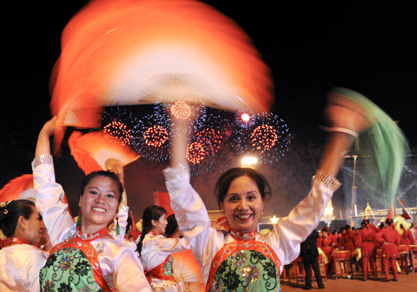 A grand evening gala is held to celebrate the People's Republic of China's 60th anniversary at the Tian'anmen Square in Beijing on Oct. 1 evening. Fireworks light up the TiDancers perform at the show. 