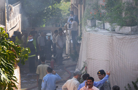 Pakistani security officials and rescue workers survey the site of a bomb blast in Islamabad October 5, 2009. (Xinhua/Reuters Photo)