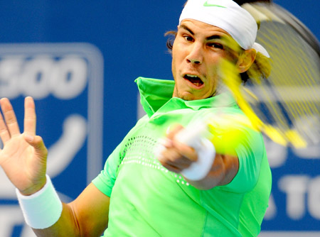 Rafael Nadal of Spain returns the ball during the men's singles second round match against James Blake of the U.S. at the China Open tennis tournament in Beijing, Oct. 8, 2009. Nadal won 2-1. (Xinhua/Chen Jianli)