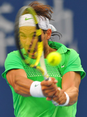 Rafael Nadal of Spain returns the ball during the men's singles second round match against James Blake of the U.S. at the China Open tennis tournament in Beijing, Oct. 8, 2009. Nadal won 2-1. (Xinhua/Luo Xiaoguang) 