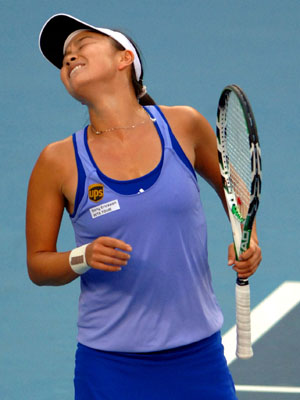 Peng Shuai of China reacts during the quarter-final match of women's singles against Nadia Petrova of Russia at China Tennis Open Tournament 2009 at National Tennis Centre in Beijing, capital of China, Oct. 9, 2009. Peng lost 1-2.[Gong Lei/Xinhua]