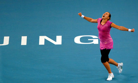 Nadia Petrova of Russia celebrates after winning her quarter-final match of women's singles against Peng Shuai of China at China Tennis Open Tournament 2009 at National Tennis Centre in Beijing, capital of China, Oct. 9, 2009. Petrova won 2-1.[Gong Lei/Xinhua]