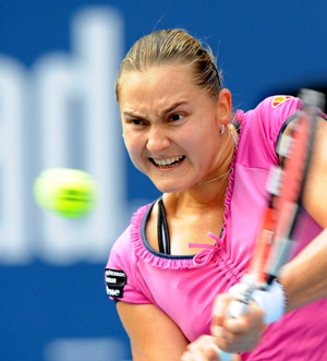 Nadia Petrova of Russia hits a return to Peng Shuai of China during the quarter-final match of women's singles at China Tennis Open Tournament 2009 at National Tennis Centre in Beijing, capital of China, Oct. 9, 2009. Petrova won 2-1.[Li Wen/Xinhua]