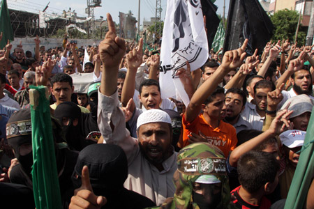 Supporters of Islamic Hamas movement shout slogans in a demonstration in central Gaza Strip on Oct. 9, 2009 to protest the recent Israeli measures against al- Aqsa Mosque in the Old City of Jerusalem. [Khaled Omar/Xinhua]