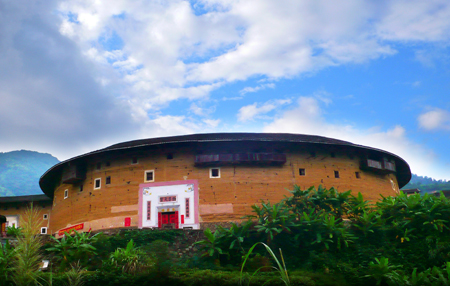 Photo taken on Oct. 6, 2009 shows the Chuxi Tulou, earth buildings in Chinese, in Yongding County, southeast China's Fujian Province. Built on a base of stone, the thick walls of Tulou were packed with dirt and fortified with wood or bamboo internally. The architectural arts of the Fujian Tulou can be traced back nearly 1,000 years, and their design incorporates the tradition of fengshui (favorable siting within the environment). Yang Xiaoming/Xinhua] 