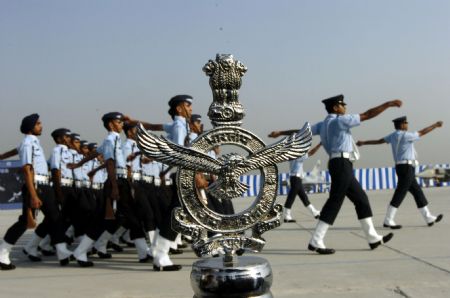 Soldiers parade past the symbol of Indian Air Force(IAF) during the Indian Air Force Day celebration on the outskirts of New Delhi, capital of India, Oct. 8, 2009. The Indian Air Force celebrated its 77th Anniversary on Thursday. [Partha Sarkar/Xinhua]