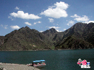 Tianchi is a lake in Xinjiang, China. The name literally means 'Heaven Lake' or 'Heavenly Lake' (in Mandarin Chinese) and can refer to several lakes in China and Taiwan. This Tianchi lies on the north side of Bogda Peak of Tianshan Mountains, about 40 km east of Fukang County and 110 km east of Urumqi, in China. (Bogda is a Mongolian word, meaning 'God'.) Formerly known as Yaochi (Jade Lake), it was named Tianchi by Mingliang in 1783, the Qing Dynasty Commander of Urumqi Command.[Photo by Wu Aifeng] 