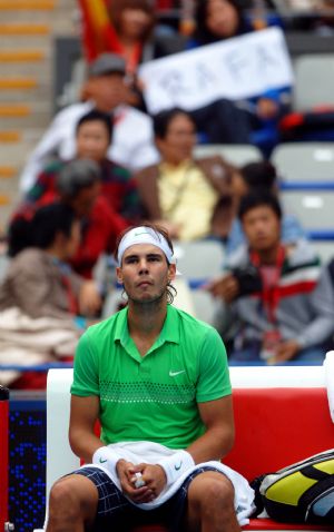 Rafael Nadal of Spain looks on during a break in the men's singles semifinal match against Marin Cilic of Croatia at the China Open tennis tournament in Beijing, Oct. 10, 2009. (Xinhua/Gong Lei)