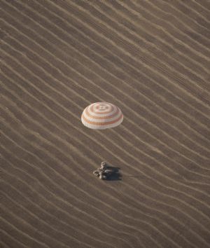 The Russian Soyuz space capsule lands with Expedition 20 Commander Gennady Padalka of Russia, Flight Engineer Michael Barratt of the U.S. and Canadian circus billionaire Guy Laliberte in the vast steppe near the town of Arkalyk in northern Kazakhstan, October 11, 2009.[Xinhua/AFP]