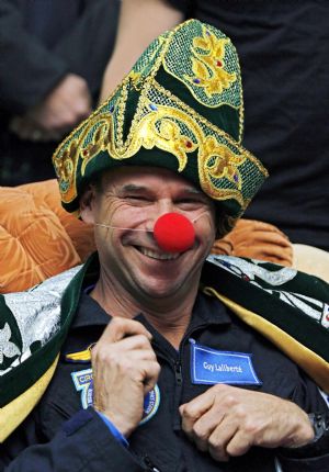 Canadian circus billionaire Guy Laliberte, in a Kazakh national costume, smiles at a news conference at Kustanai airport, October 11, 2009, before his departure to Moscow. Laliberte returned from the International Space Station (ISS) after staying about two weeks in space.[Xinhua/Reuters]