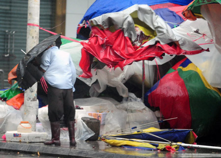 A batch of tabernacle umbrellas scatter on the ground after being blown down by gale in Qionghai City, as the forefront of tropical storm Parma starts to affect south China's Hainan Province, Oct. 12, 2009. [Meng Zhongde/Xinhua]