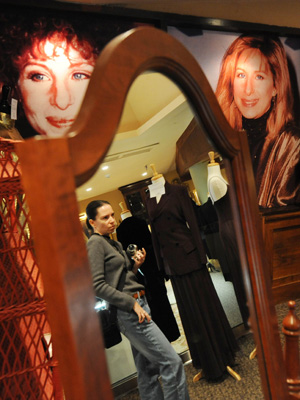 A visitor looks over items owned by Barbra Streisand shown at a press preview of items from the auction 'The Collection of Barbra Streisand' in Beverly Hills October 12, 2009. Julien's Auctions will offer items collected by singer Barbra Streisand at the auction on October 17 and 18, with proceeds going to The Streisand Foundation. [Xinhua/AFP]