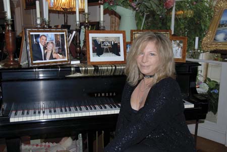 Singer Barbra Streisand sits at her Yamaha Baby Grand Piano estimated to bring $10,000 in this 2009 publicity photograph. The piano is on display at a press preview of items from the auction 'The Collection of Barbra Streisand' in Beverly Hills October 12, 2009. [Xinhua/Reuters]