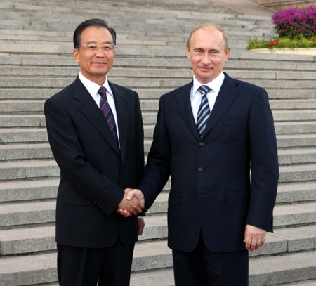 Chinese Premier Wen Jiabao (L) shakes hands with visiting Russian Prime Minister Vladimir Putin in Beijing on Oct. 13, 2009.