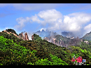 Mount Huang, also known as Huangshan is a mountain range in southern Anhui province in eastern China. The area is well known for its scenery, sunsets, peculiarly-shaped granite peaks, Huangshan Pine trees, and views of the clouds from above. Mount Huang is a frequent subject of traditional Chinese paintings and literature, as well as modern photography. [Photo by Liu Xingguo]