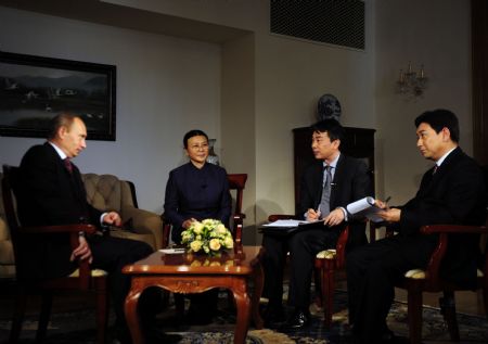 Russian Prime Minister Vladimir Putin (L) is interviewed by Peng Shujie (2nd R), deputy chief editor of Xinhua News Agency, Ma Li (3rd R), deputy chief editor of People's Daily, and Shui Junyi, TV host from China Central Television (CCTV), in Beijing, capital of China, Oct. 13, 2009. (Xinhua/Zhang Duo)
