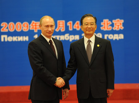 Chinese Premier Wen Jiabao (R) shakes hands with his Russian counterpart Vladimir Putin prior to the eighth prime ministers' meeting of the Shanghai Cooperation Organization member states at the Great Hall of the People in Beijing, capital of China, Oct. 14, 2009. (Xinhua/Ma Zhancheng)