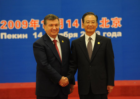 Chinese Premier Wen Jiabao (R) shakes hands with Uzbek Prime Minister Shavkat Mirziyaev prior to the eighth prime ministers' meeting of the Shanghai Cooperation Organization member states at the Great Hall of the People in Beijing, capital of China, Oct. 14, 2009. (Xinhua/Ma Zhancheng)