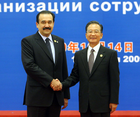 Chinese Premier Wen Jiabao (R) shakes hands with Kazakh Prime Minister Karim Masimov prior to the eighth prime ministers' meeting of the Shanghai Cooperation Organization member states at the Great Hall of the People in Beijing, capital of China, Oct. 14, 2009. (Xinhua/Liu Weibing)