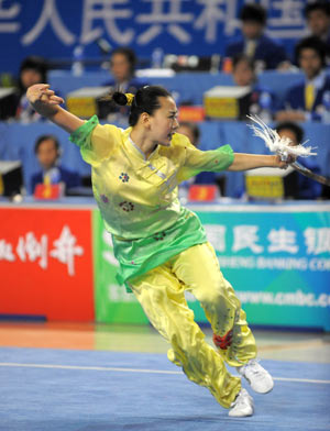 Kan Wencong from Hebei competes during the swordplay competition of women's individual all-around event for spearplay and swordplay in martial arts at China's 11th National Games in Binzhou, east China's Shandong Province, Oct. 13, 2009. Kan ranked the second place with 19.63 points in total. [Xu Yu/Xinhua]