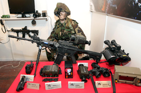 Tactical night vision systems are displayed at the Israel Defense Exhibition in Tel Aviv Wednesday October 14, 2009. This unmanned helicopter developed by 'Steadicopter', an Israeli 3D aerial robotics company, has a range of 150 kms. Many new products for the military, police and security markets were shown at the exhibition. [Xinhua]