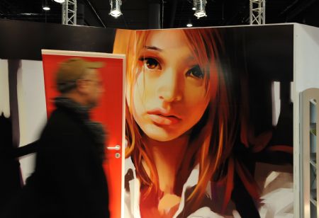 A visitor passes a poster of Chinese cartoons at the 61st Frankfurt Book Fair in the central German city of Frankfurt, Oct. 14, 2009.