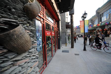 A featured hotel is seen on the Dashila West Street of Beijing, capital of China, on Oct. 15, 2009. The Dashila West Street used to be called Guanyinsi Street in the old times. The 323-meter long street, which reopened on Thursday, is one of the most historic featured streets in Beijing. [Zhang Xu/Xinhua]