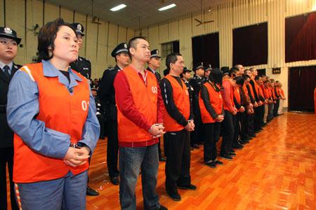 Xie Caiping (1st L, front) and other suspects go on trial at the Fifth Intermediate People&apos;s Court of Chongqing Municipality, in southwest China&apos;s Chongqing, Oct. 14, 2009. [Yang Lei/Xinhua] 