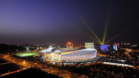 The gleams of lights from a well-decorated Jinan Olympic Sports Center Stadium show the full preparation of the city for the opening ceremony of the 11th National Games held in Jinan, Shandong Province Oct 16, 2009. [Xinhua]