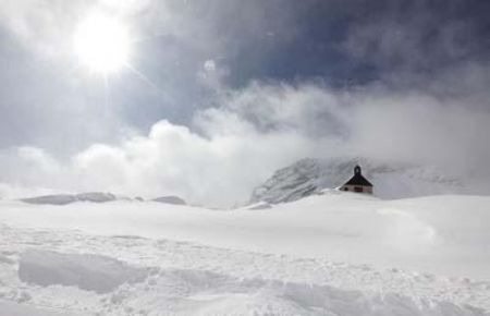 A little chapel, covered with snow, is pictured on Germany's highest mountain, the 2,962 metre (9,718 feet) Zugspitze, after the first snowfall of the season.[CCTV]