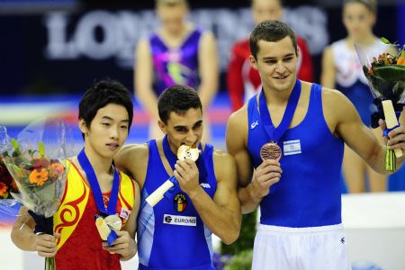 Gold medalist Marian Dragulescu of Romania (C), silver medalist Zou Kai of China (L) and bronze medalist Alexander Shatilov of Israel pose during the victory ceremony of the Floor Exercise final of the 41st Artistic Gymnastics World Championships in London, Britain, Oct. 17, 2009. (Xinhua/Zeng Yi) 