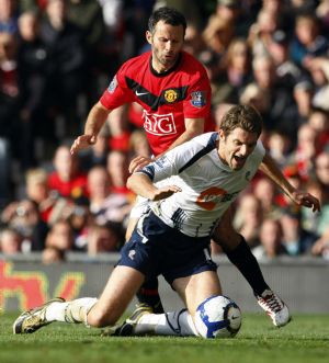 Manchester United's Ryan Giggs challenges Bolton Wanderers' Sam Ricketts (R) during their English Premier League soccer match in Manchester, northern England, October 17, 2009.[Xinhua/Reuters]