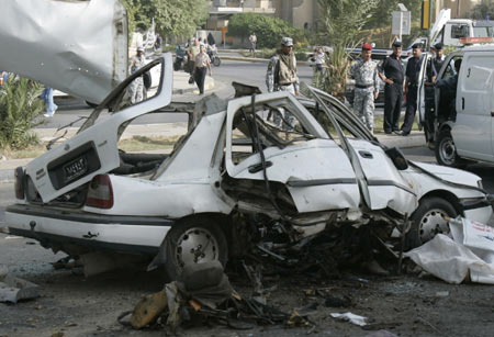 A destroyed vehicle is seen after a bomb attack in Baghdad, October 18, 2009. 