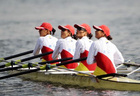 Athletes of Zhejiang team react after the final of women's quadruple sculls without coxswain event of rowing at the 11th Chinese National Games in Rizhao, east China's Shandong Province, Oct. 20, 2009. Zhejiang team claimed the title with 6 minutes and 33.69 seconds. [Zhu Zheng/Xinhua]