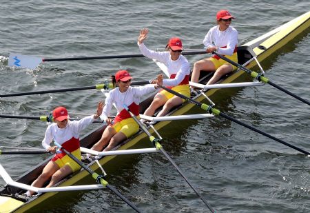Athletes of Zhejiang team react after the final of women's quadruple sculls without coxswain event of rowing at the 11th Chinese National Games in Rizhao, east China's Shandong Province, Oct. 20, 2009. Zhejiang team claimed the title with 6 minutes and 33.69 seconds. [Wang Song/Xinhua]