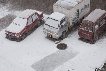 Vehicles covered with snow are seen in Hexigten Banner, north China's Inner Mongolia Region, Oct. 20, 2009. A snowfall hit the area on Tuesday. [Xinhua]