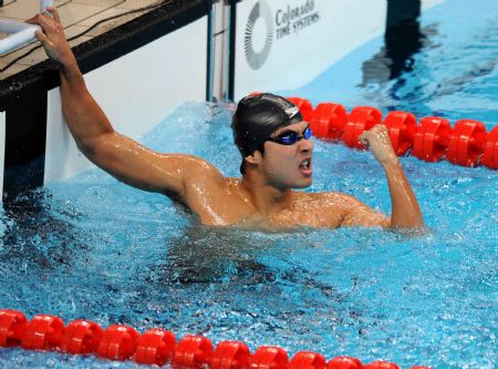 Zhejiang's Wu Peng celebrates after winning the men's 200m butterfly final at the 11th Chinese National Games in Jinan, east China's Shandong Province, Oct. 20, 2009. Wu clocked 1 minute 54.40 seconds to win the title. [Xinhua]